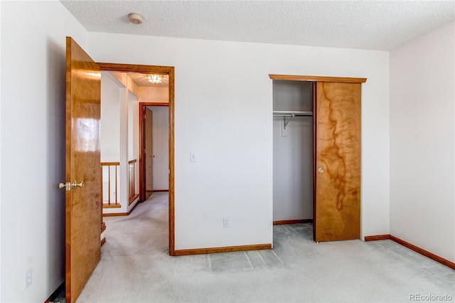 unfurnished bedroom with light colored carpet, a closet, and baseboards