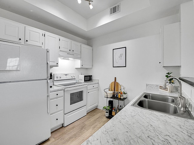 kitchen with visible vents, white cabinets, a sink, white appliances, and under cabinet range hood