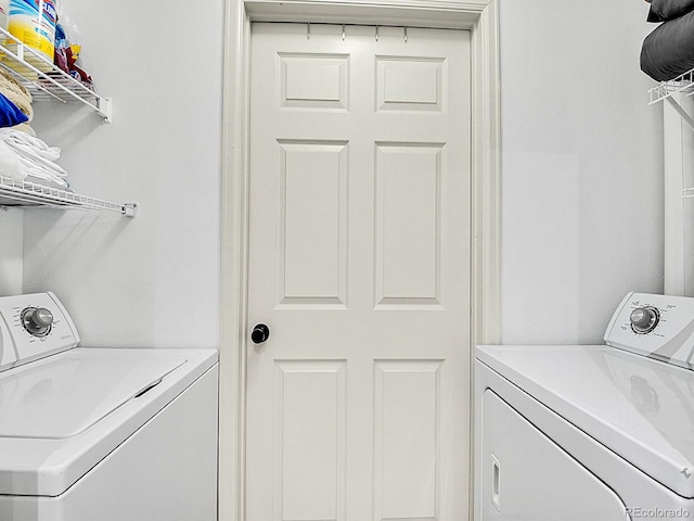 clothes washing area with laundry area and washer and clothes dryer