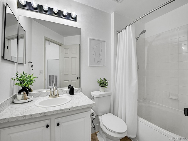 full bath with shower / tub combo, vanity, and toilet