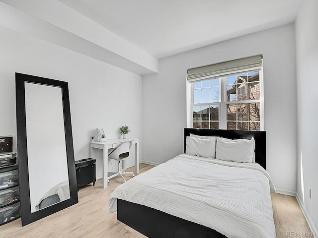 bedroom featuring light wood-type flooring and baseboards