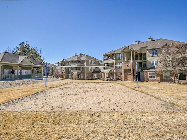 view of home's community with volleyball court and a residential view