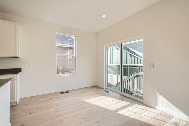 unfurnished dining area with light wood-type flooring