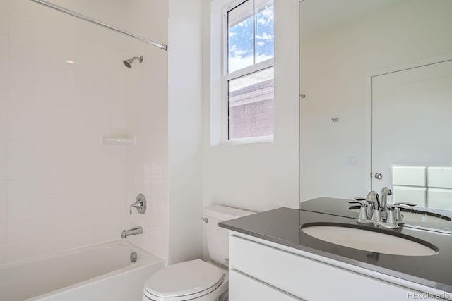 full bathroom with vanity, tiled shower / bath combo, and toilet