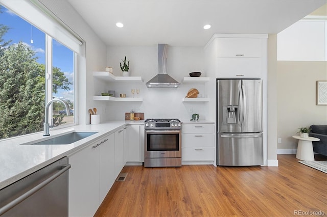 1340 W 68th Ave, Denver, CO 80221 - kitchen featuring stainless steel appliances, wall chimney exhaust hood, open shelves, a sink, and recessed lighting