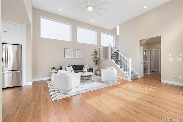 1340 W 68th Ave, Denver, CO 80221 - living room with a towering ceiling, light wood-style flooring, stairway, a ceiling fan, and recessed lighting