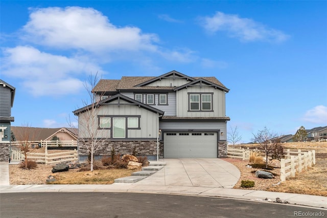 craftsman-style home with stone siding, board and batten siding, and fence