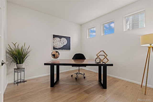 office with baseboards and light wood-style floors