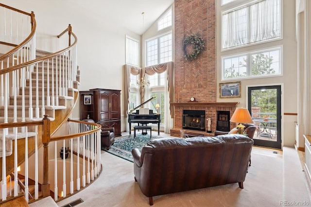 9416 Kemper Dr, Lone Tree, CO 80124 - carpeted living room featuring a towering ceiling, a brick fireplace, and stairs
