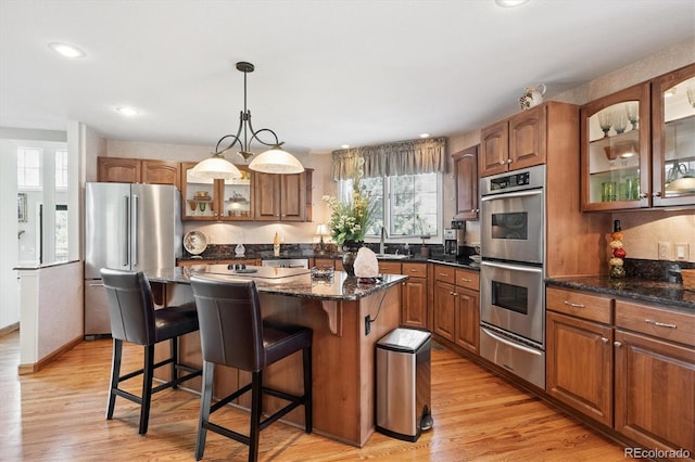 9416 Kemper Dr, Lone Tree, CO 80124 - kitchen with appliances with stainless steel finishes, a warming drawer, plenty of natural light, a kitchen island, and recessed lighting