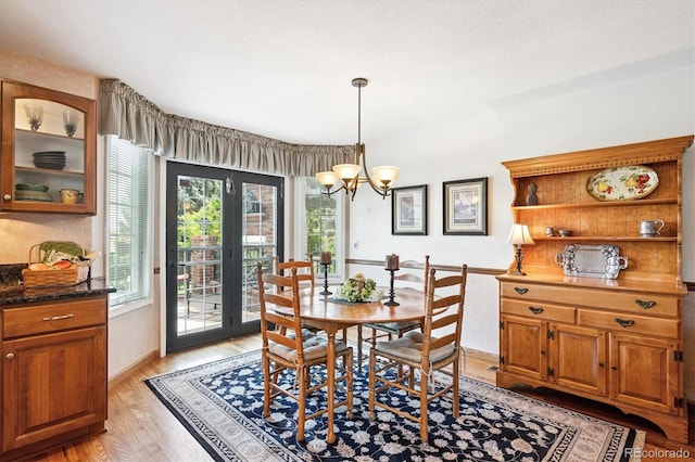 9416 Kemper Dr, Lone Tree, CO 80124 - dining area featuring light wood finished floors and a chandelier