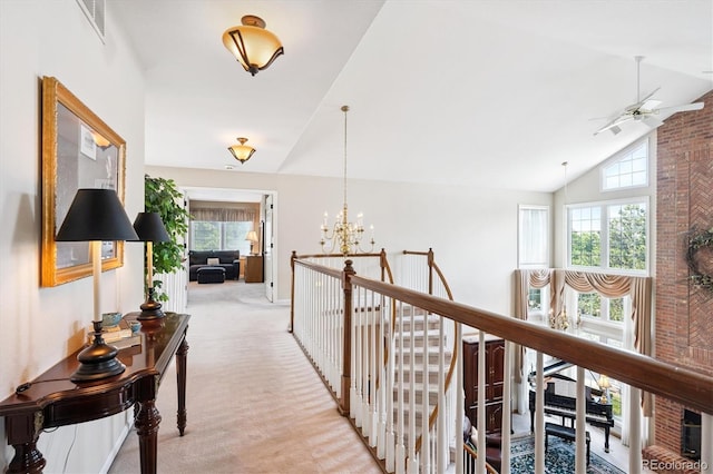 9416 Kemper Dr, Lone Tree, CO 80124 - hallway with light carpet, a chandelier, and high vaulted ceiling