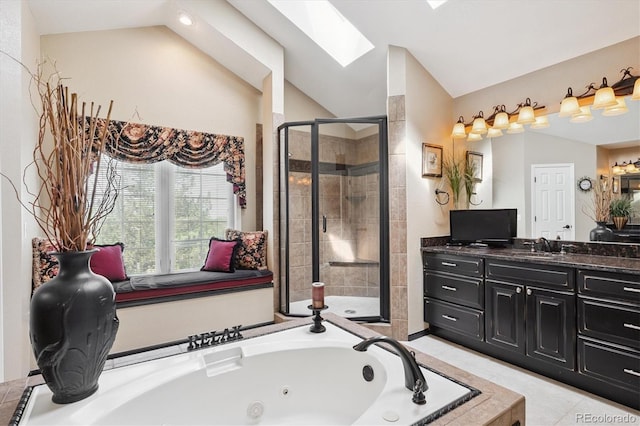 9416 Kemper Dr, Lone Tree, CO 80124 - bathroom featuring vaulted ceiling, a stall shower, a tub with jets, vanity, and a skylight