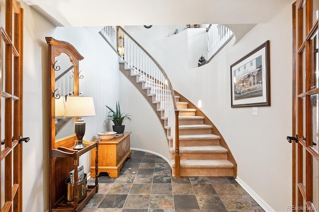 9416 Kemper Dr, Lone Tree, CO 80124 - foyer featuring stone tile floors and stairs
