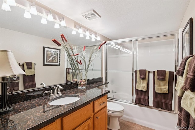 9416 Kemper Dr, Lone Tree, CO 80124 - full bathroom featuring vanity, enclosed tub / shower combo, tile patterned flooring, and a textured ceiling