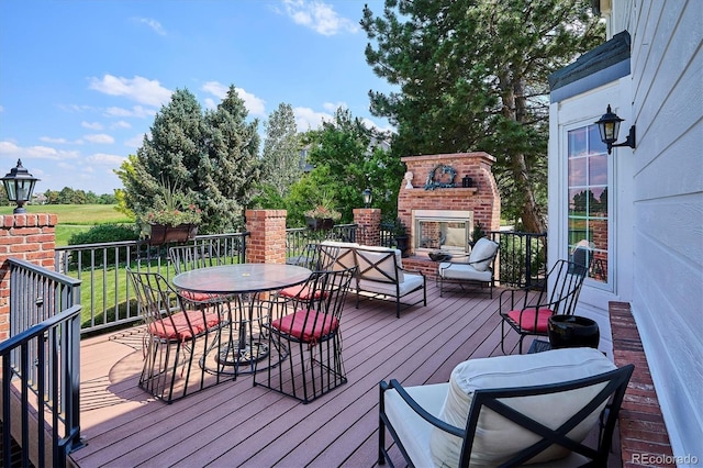 9416 Kemper Dr, Lone Tree, CO 80124 - wooden terrace with a brick fireplace and outdoor dining area