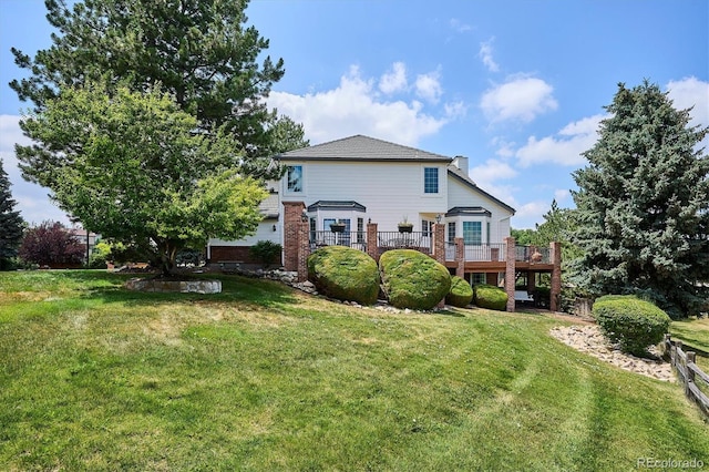 9416 Kemper Dr, Lone Tree, CO 80124 - rear view of house with a deck, a lawn, and a chimney