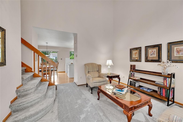 9717 Castle Ridge Cir, Highlands Ranch, CO 80129 - living area with stairs, carpet flooring, and a towering ceiling