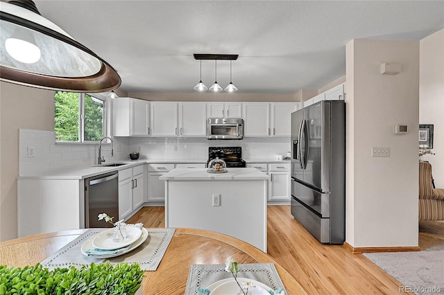 9717 Castle Ridge Cir, Highlands Ranch, CO 80129 - kitchen featuring stainless steel appliances, light countertops, white cabinets, and decorative backsplash