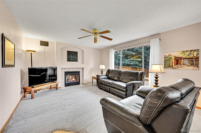 9717 Castle Ridge Cir, Highlands Ranch, CO 80129 - carpeted living room featuring ceiling fan, a textured ceiling, and a tile fireplace