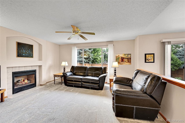 9717 Castle Ridge Cir, Highlands Ranch, CO 80129 - carpeted living room featuring a tile fireplace, a ceiling fan, and a textured ceiling