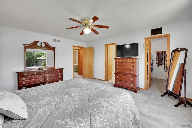 9717 Castle Ridge Cir, Highlands Ranch, CO 80129 - carpeted bedroom with a textured ceiling, a walk in closet, and ceiling fan