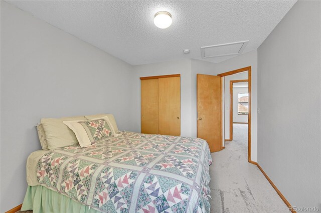 9717 Castle Ridge Cir, Highlands Ranch, CO 80129 - carpeted bedroom featuring a textured ceiling, attic access, and a closet