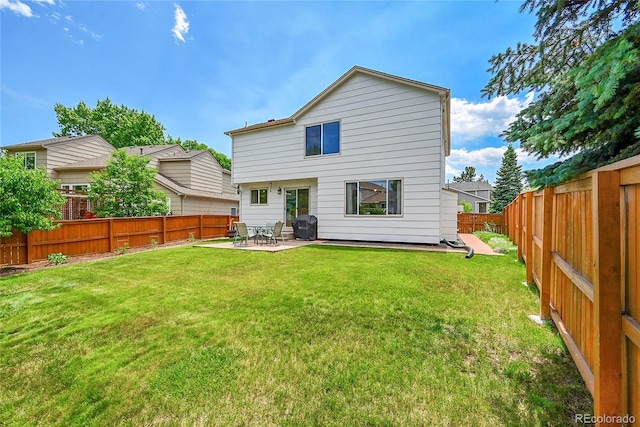 9717 Castle Ridge Cir, Highlands Ranch, CO 80129 - back of property with a fenced backyard and a patio area