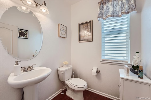 bathroom with a wealth of natural light, hardwood / wood-style flooring, and toilet