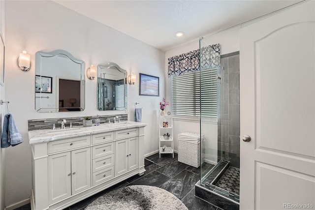 bathroom with a tile shower and vanity