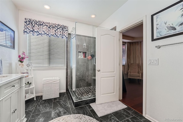 bathroom with vanity and a shower with shower door