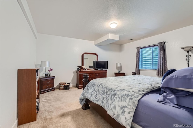 carpeted bedroom featuring a textured ceiling