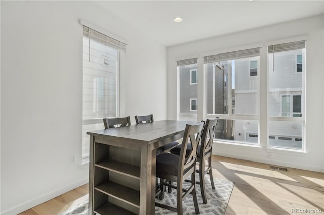 dining room featuring recessed lighting, wood finished floors, visible vents, and baseboards