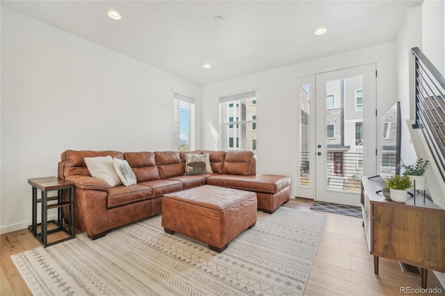 living room featuring recessed lighting, light wood-style floors, and baseboards