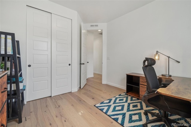 home office with visible vents, baseboards, and wood finished floors