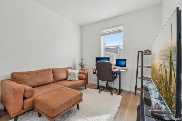 office space featuring baseboards and light wood-type flooring