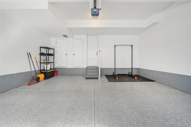 garage with visible vents and a garage door opener