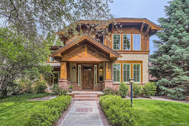 1410 S Elizabeth St, Denver, CO 80210 - view of front of property featuring stucco siding, a front lawn, and brick siding