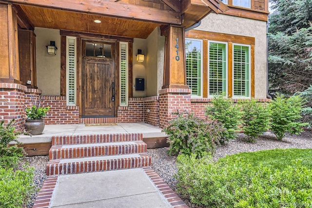 1410 S Elizabeth St, Denver, CO 80210 - entrance to property featuring stucco siding, brick siding, and covered porch