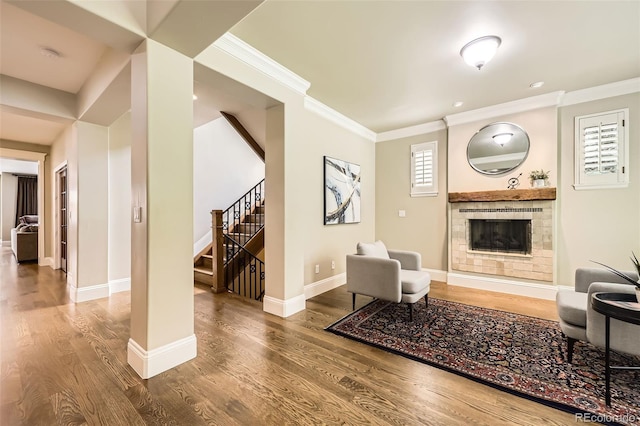 1410 S Elizabeth St, Denver, CO 80210 - living area with a fireplace, wood finished floors, stairs, baseboards, and ornamental molding