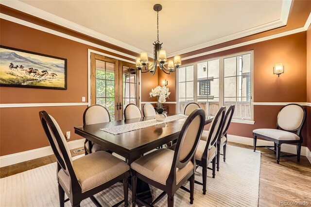 1410 S Elizabeth St, Denver, CO 80210 - dining space with a chandelier, baseboards, ornamental molding, light wood-type flooring, and a raised ceiling