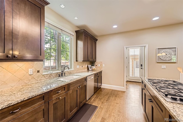 1410 S Elizabeth St, Denver, CO 80210 - kitchen featuring a sink, stainless steel appliances, light wood-type flooring, light stone countertops, and recessed lighting