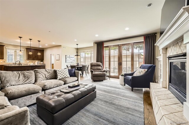 1410 S Elizabeth St, Denver, CO 80210 - living area with plenty of natural light, recessed lighting, a high end fireplace, and french doors