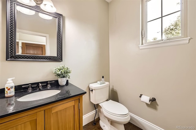 1410 S Elizabeth St, Denver, CO 80210 - bathroom with toilet, vanity, and baseboards