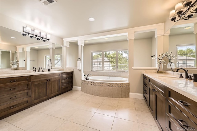 1410 S Elizabeth St, Denver, CO 80210 - bathroom with two vanities, a bath, decorative columns, baseboards, and recessed lighting