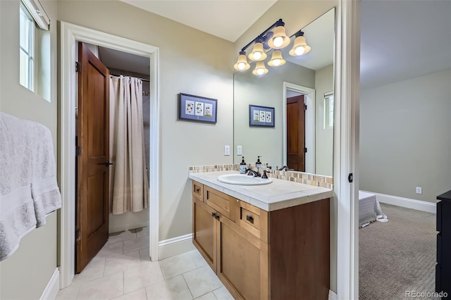 1410 S Elizabeth St, Denver, CO 80210 - bathroom featuring vanity, baseboards, and tile patterned floors