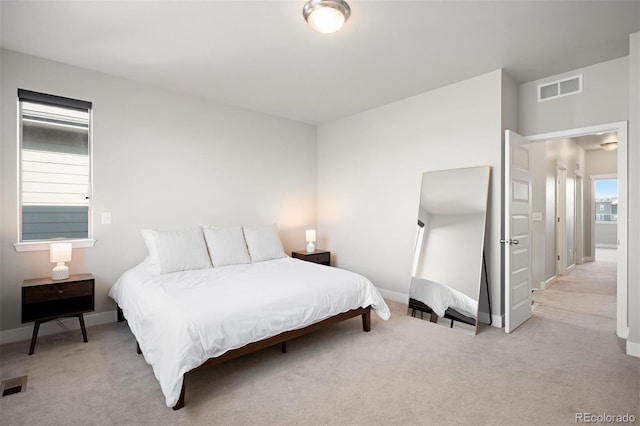 carpeted bedroom with multiple windows