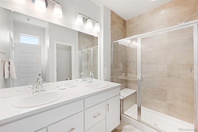 bathroom featuring vanity and an enclosed shower