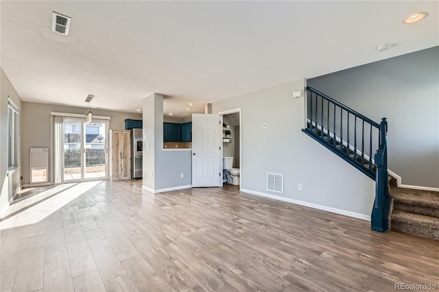 unfurnished living room with hardwood / wood-style flooring