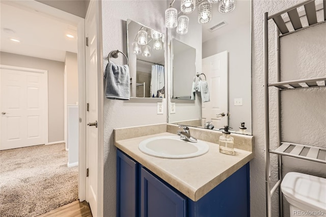 bathroom featuring vanity and toilet